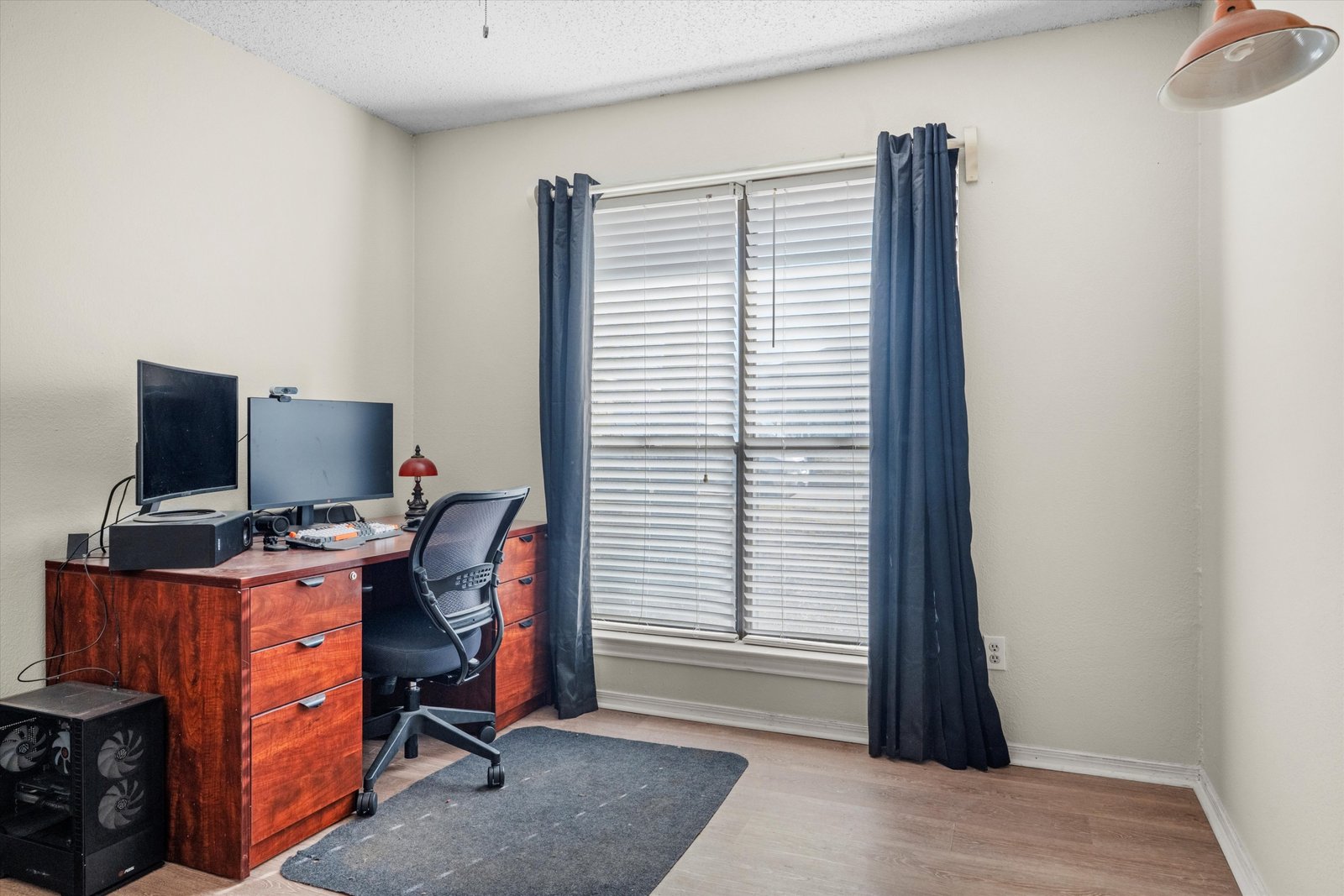 13-1613 St James Dr-13 Third bedroom currently used as a home office with window, neutral walls, and wood-look flooring at 1613 Saint James Drive.