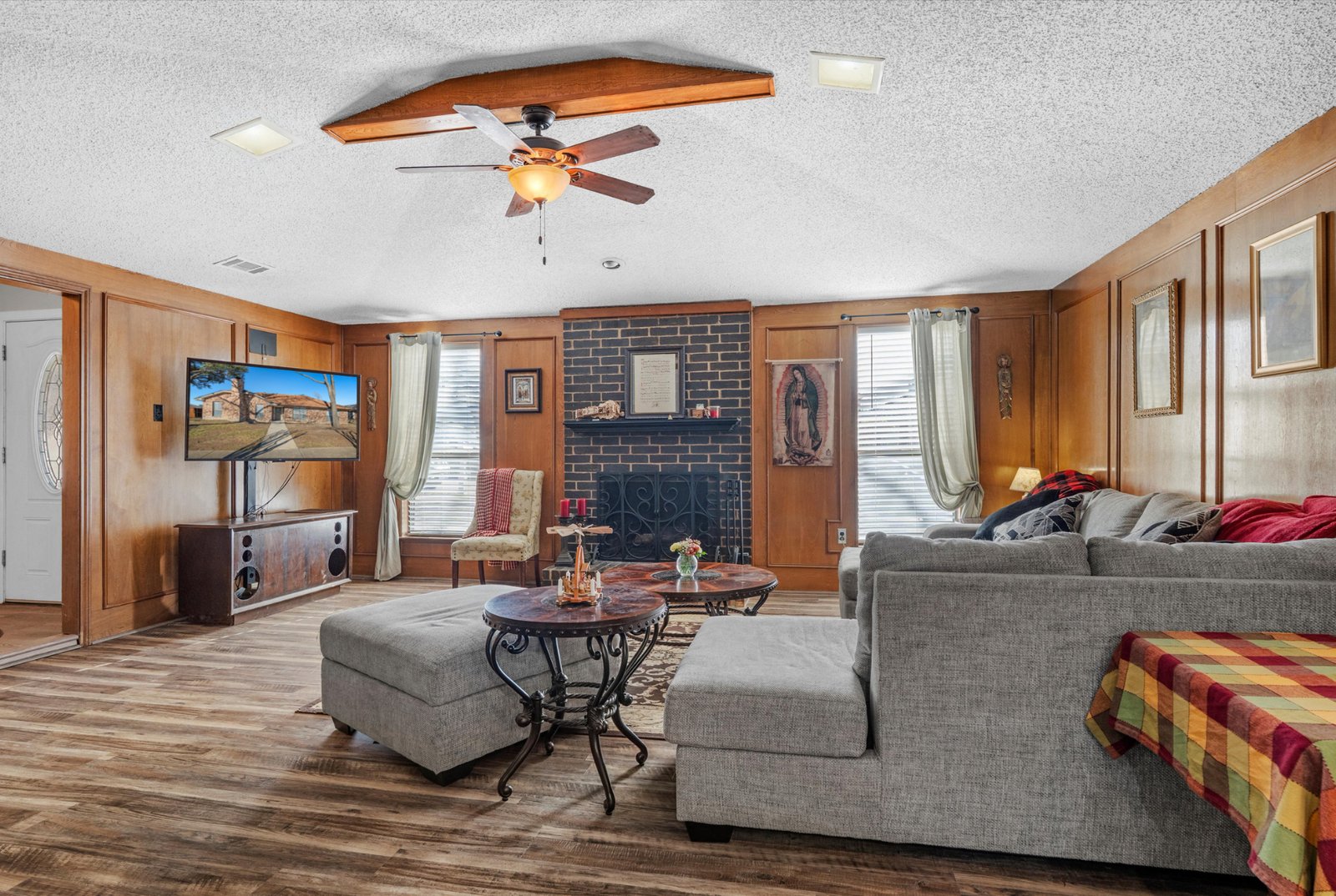 1613 St James Living Room 2 Spacious living room with vaulted ceiling, ceiling fan, and abundant natural light at 1613 Saint James Drive.