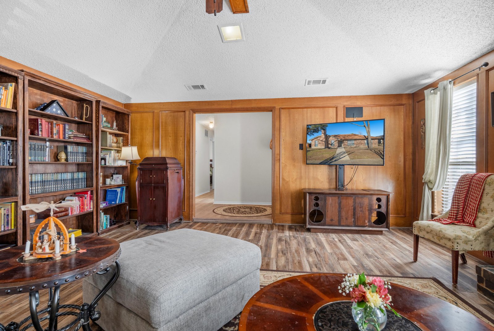 1613 St James Living Room Spacious living room with vaulted ceiling, ceiling fan, and abundant natural light at 1613 Saint James Drive.
