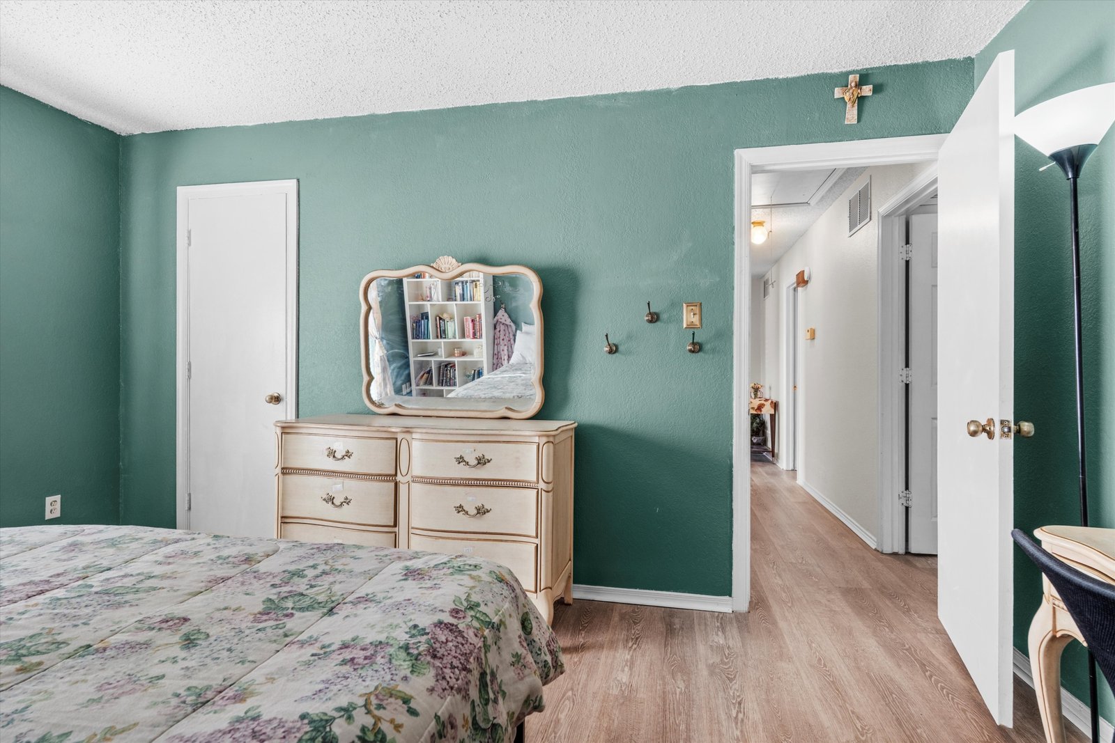 18-1613 St James Dr-18 Secondary bedroom with ceiling fan, wood-look flooring, and neutral color palette at 1613 Saint James Drive.