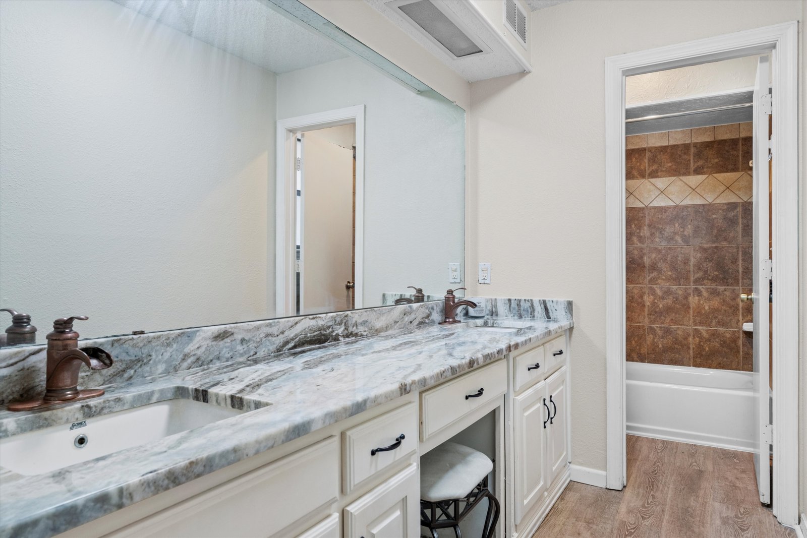 22-1613 St James Dr-22 Primary bathroom with dual sinks, stone-style countertop, and extended vanity space at 1613 Saint James Drive.