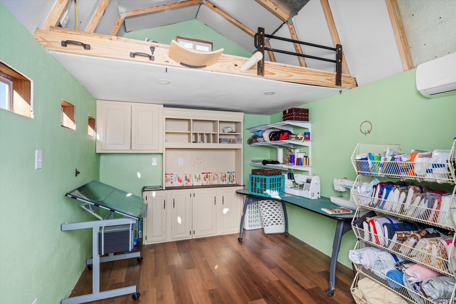 26-1613 St James Dr-26 Interior of bonus shed featuring finished space, built-in storage, loft area, and heating and cooling at 1613 Saint James Drive.