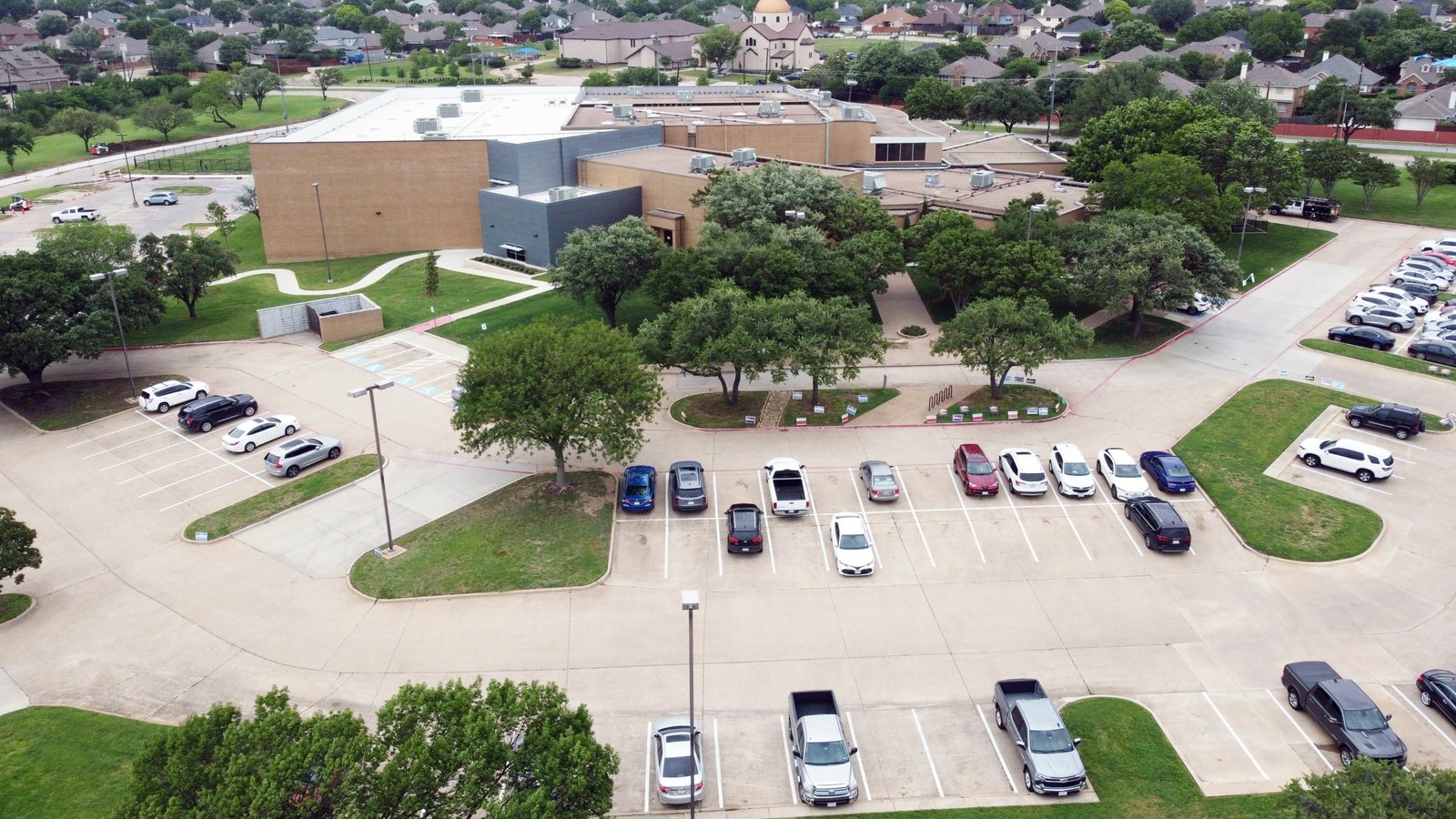 DCIM100MEDIADJI_0535.JPG Aerial view of Rosemeade Recreation Center near 1613 Saint James Drive, offering gyms, courts, fitness areas, and multipurpose spaces.