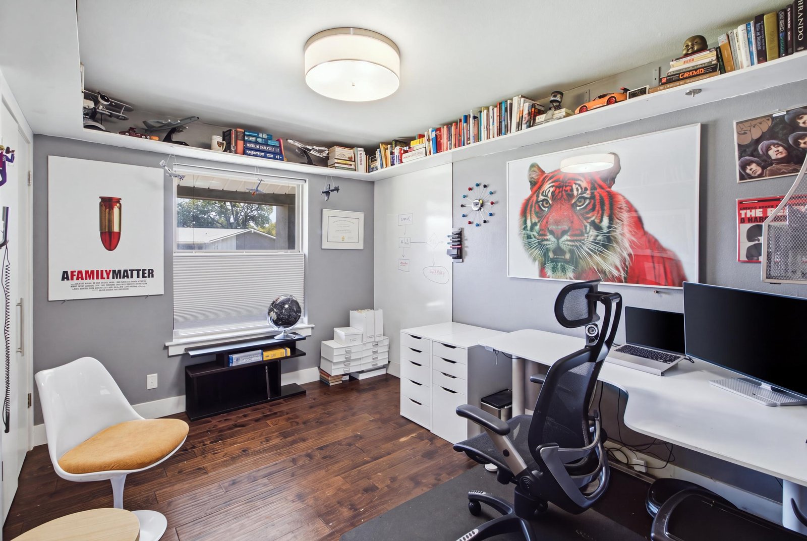 20_img_0086_reedit_dc1c3e38 Currently arranged as a home office, this secondary bedroom demonstrates the home's flexible living spaces. Rich flooring, contemporary lighting, and extensive upper-wall shelving create a distinctive workspace, while a large window brings in natural light. The room can easily serve as a traditional bedroom, study, or creative retreat to suit your needs.