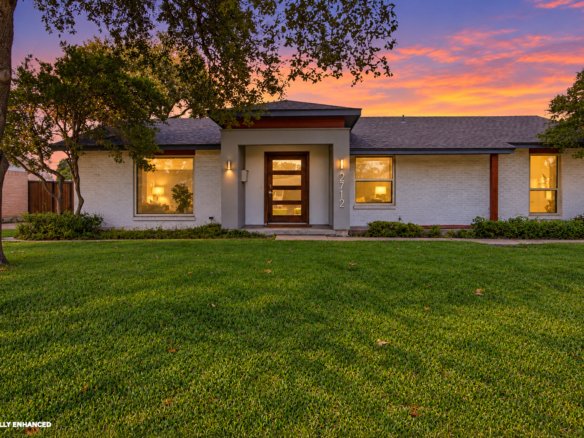 Welcome to 2712 Beechmont Place, where contemporary updates and mid-century modern influences meet the charm of an established neighborhood. A white brick exterior, distinctive modern entryway, and warm architectural lighting create an inviting first impression. Mature trees, an expansive front lawn, and thoughtfully arranged landscaping complement the home's clean lines and attractive single-story design.